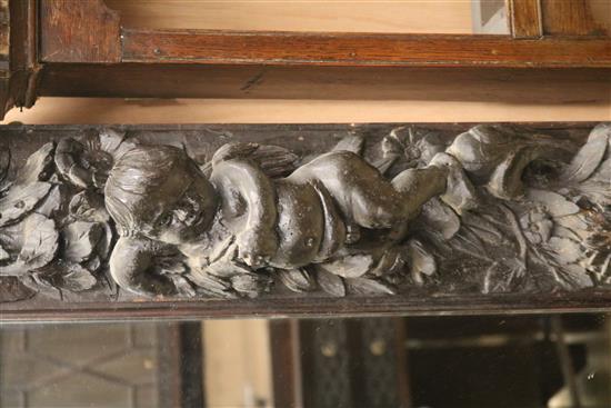 A Victorian heavily carved and painted oak overmantel W.150cm